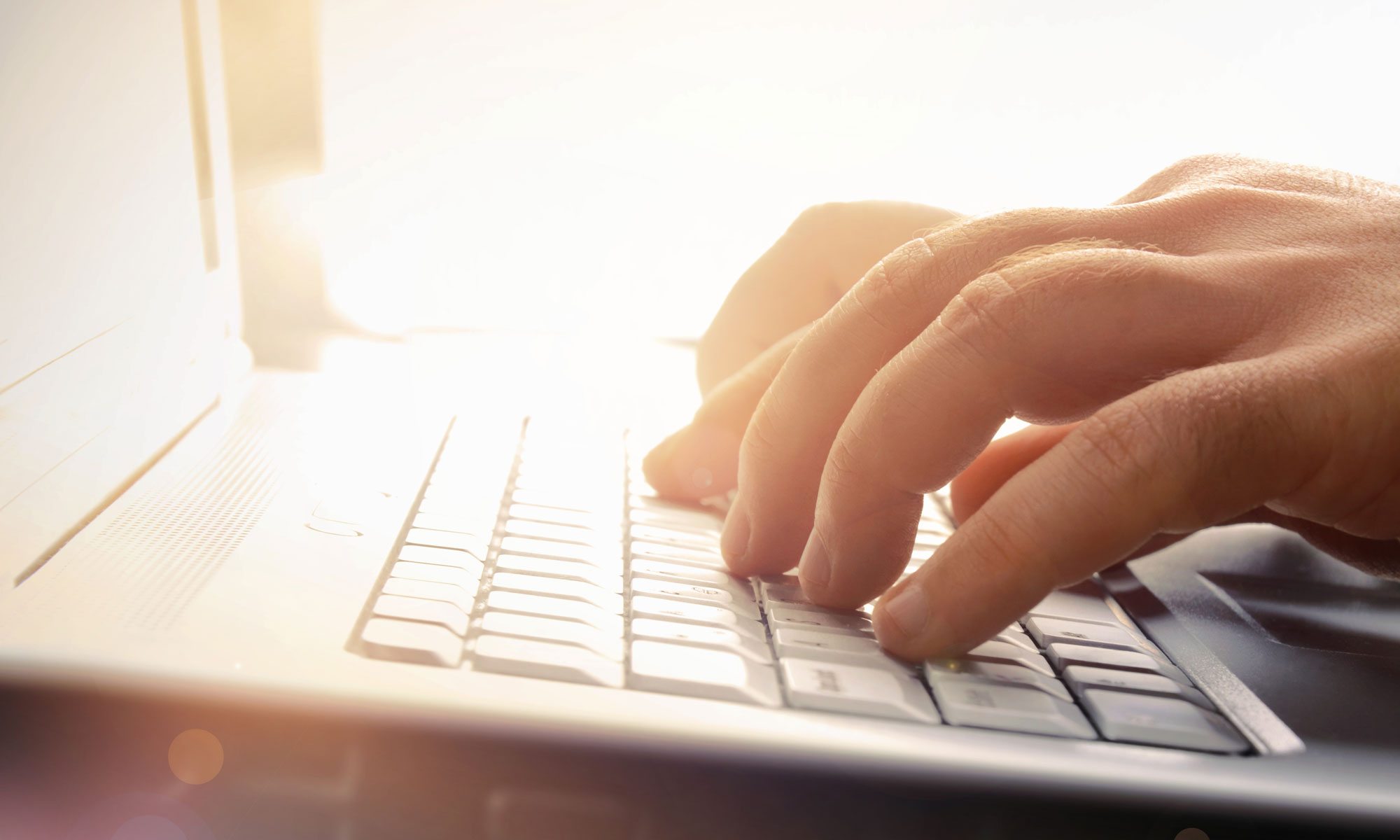 Image: man typing on computer
